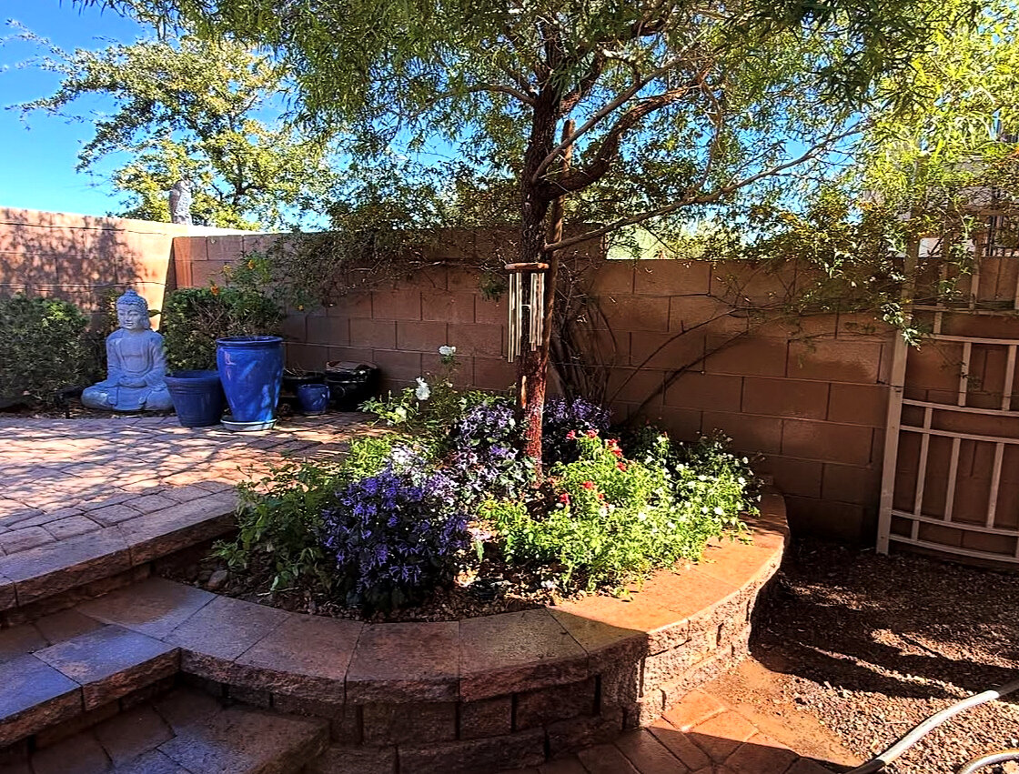 After: backyard flower bed with paver patio